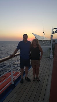 My husband and I  with the sunset in the background