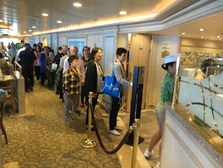 Line at buffet for food.