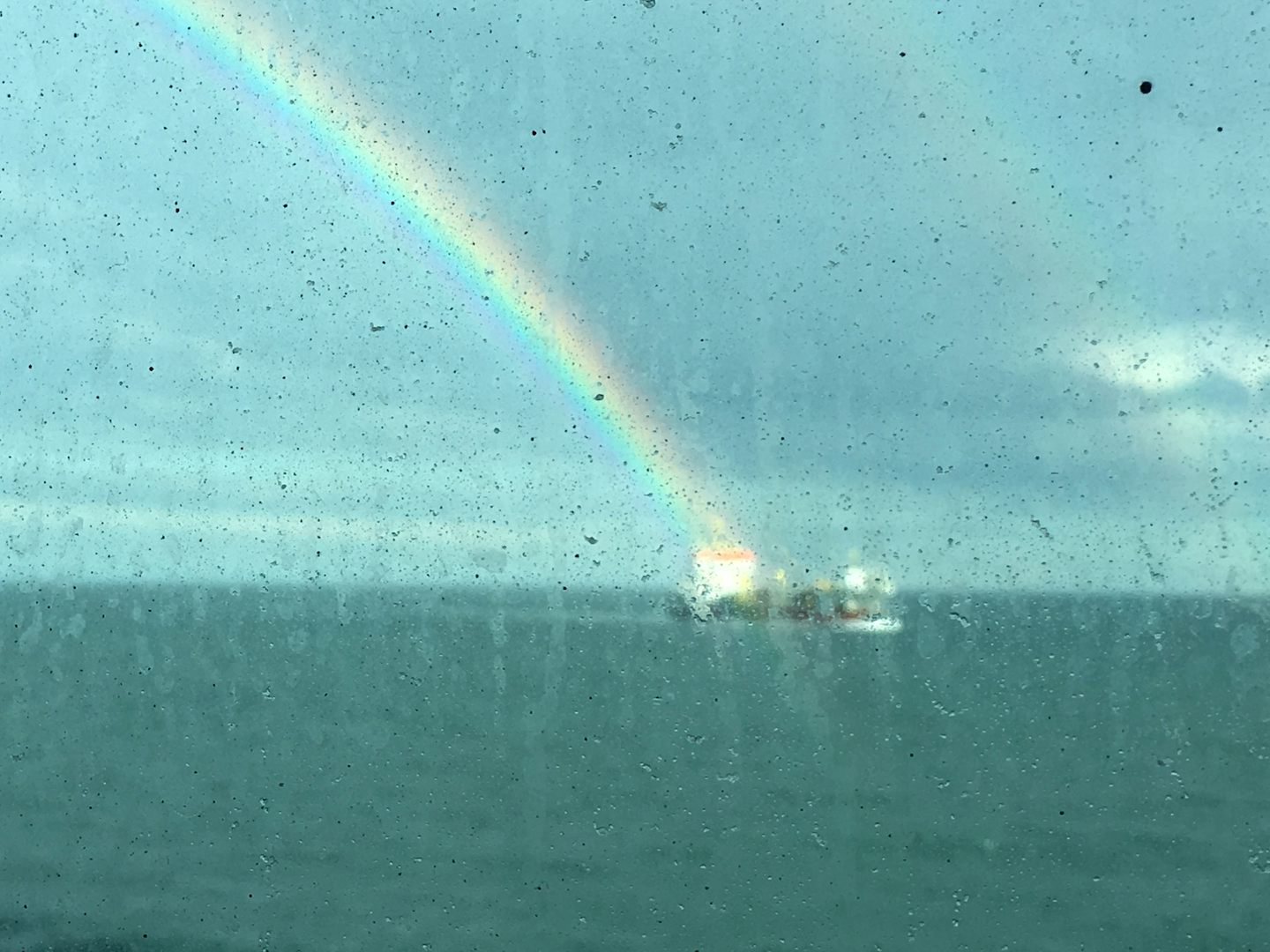 Pot of gold landing on this oil tanker (as you can see, windows from dining room)