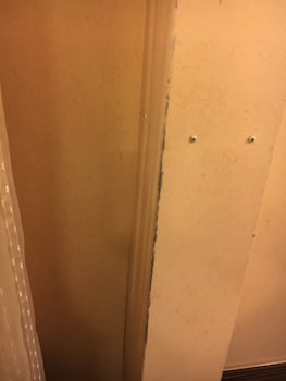 Frame in bathroom door - cracked,  scuffed,  and worn