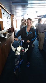 Julie standing next to the Captains scooter on the bridge of the Navigator