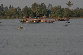 Sampans in the Mekong and houses along the shore