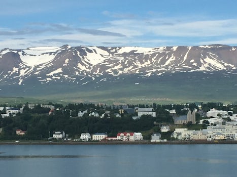 Sailing into port in Iceland with beautiful snow capped mountains in the background.