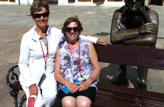 Sisters on tour. Sitting with the waiting soldier in Bratislava square.