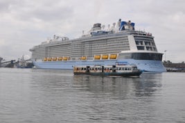 Ovation of the Seas in Cochin India harbor with harbor ferry.