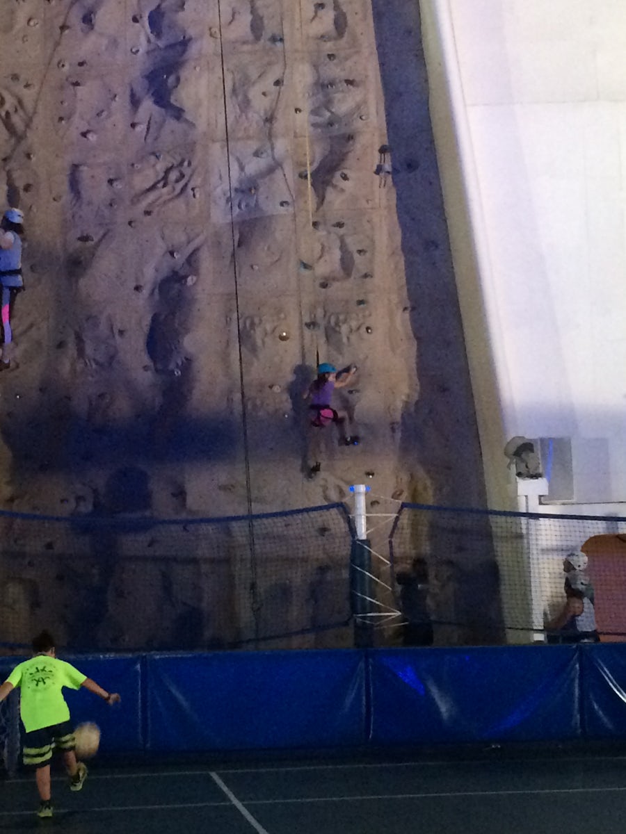 family on rock wall