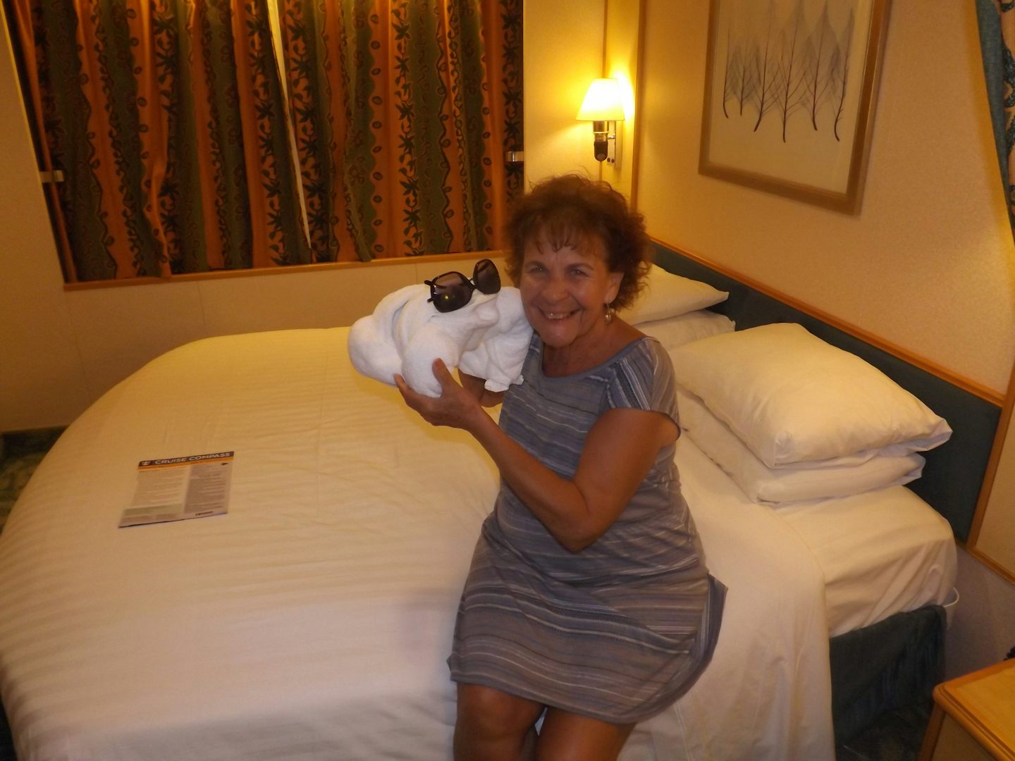 Joyce holding up towel Animal in our cabin