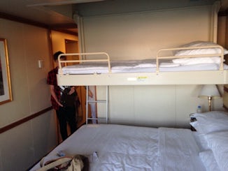 Bed lowers from ceiling and is over the main bed (may as well be a bunk bed