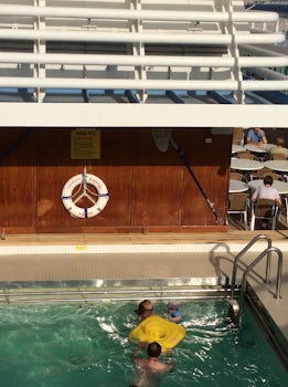 Children in the Adult pool underneath a sign which clearly states - " A