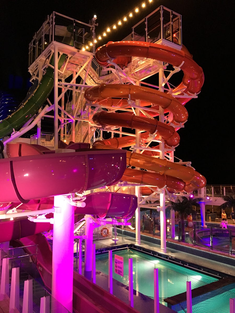 Water slides and pool at night.