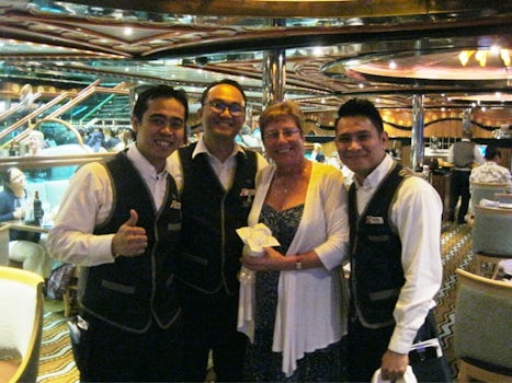 Our dining room staff and my wife with her rose at the final nights dinner.