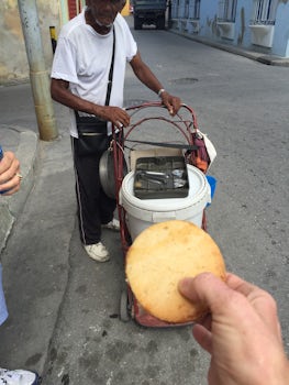 Street vendor.  A corn cake with Nutella? (peanut butter) between.  He was