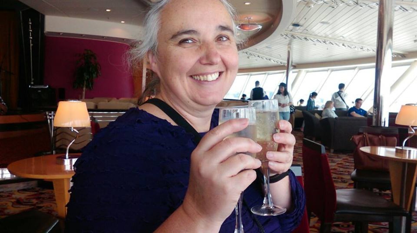 The missus with a glass of Champers at the olive or twist bar atop the ship