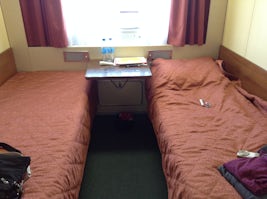 cabin, single bed with table . large window.