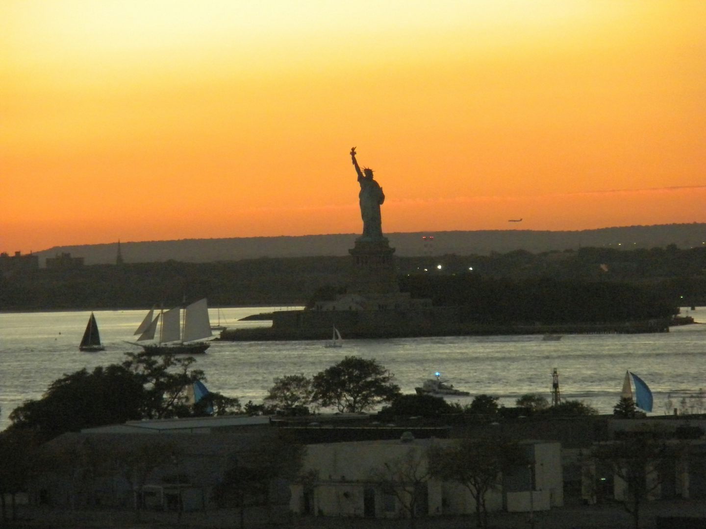 sunset New York City with statue of Liberty