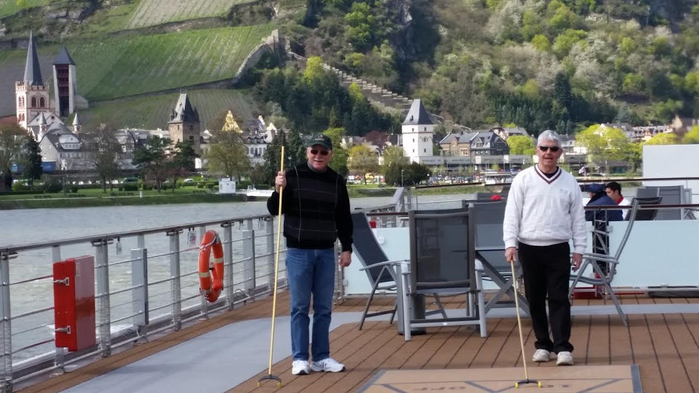 Friends playing shuffleboard while cruising the Rhine.