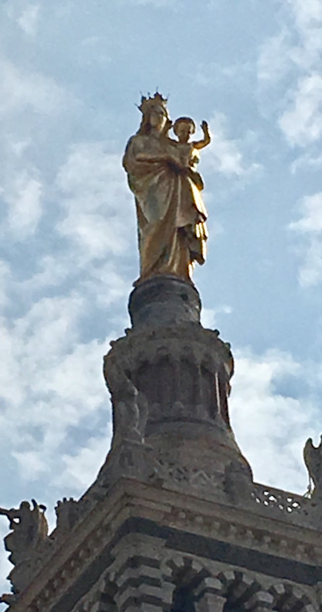 Statue at the top of a cathedral
