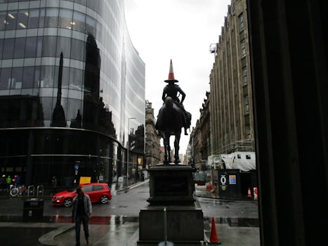 Traffic cone demonstration on statue top, downtown Glasgow