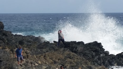 My husband on a rocky beach cliff in Aruba during our Trikes of Aruba tour.