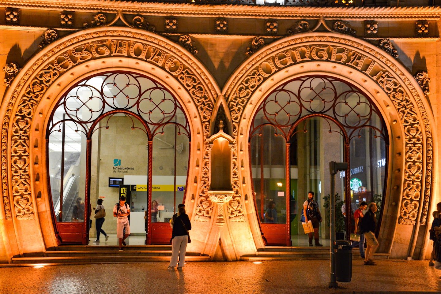 Lisbon's gorgeous Rossio train station entrance bathed in the warm glow.