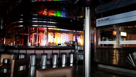 Bar on promenade deck, close to live music, casino, smoking, trivia, comedy lounge, etc.