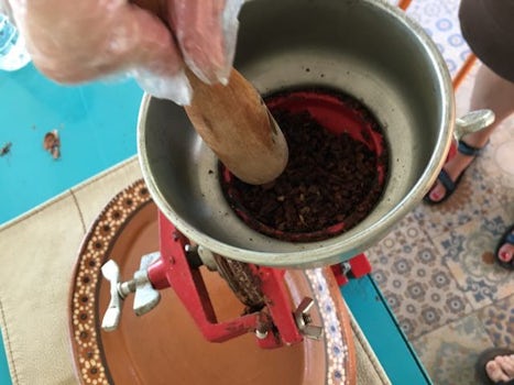 Grinding cocoa beans and cinnamon into chocolate on Cozumel.  This was part