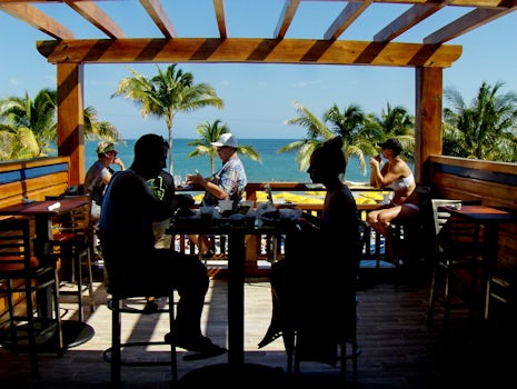 Couple eating at Landshark's 2nd floor view in Harvest Caye Belize