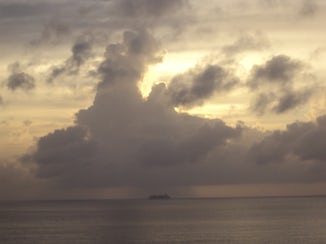 Ship in distance under cloud