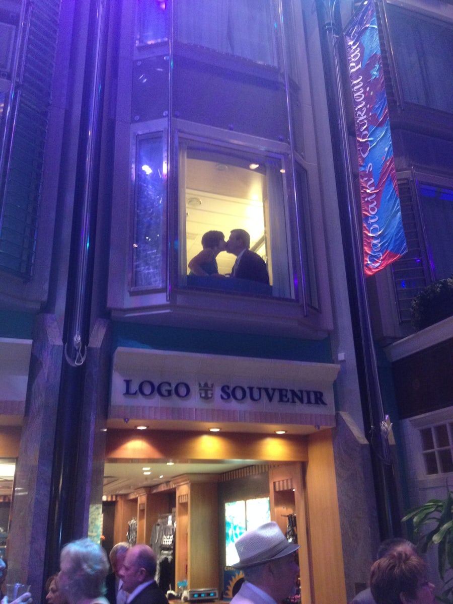 We were traveling with our friends pictured in the photo.  I wanted to capture a picture of them kissing in the window of their room from the promenade, right over the LOGO & SOUVENIR Shop.  The picture came out lovely, showing Love from the promenade of the Explorer of the Seas.