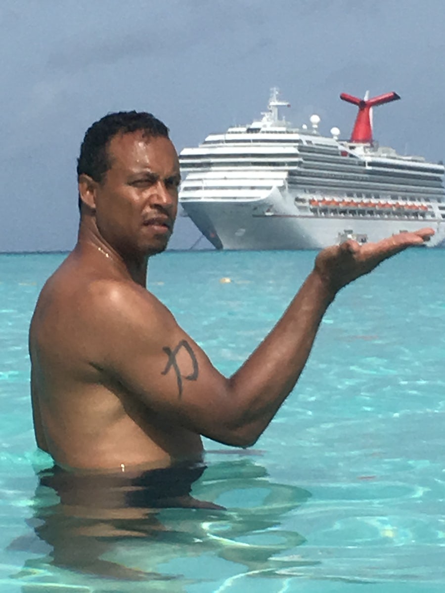 My husband holding Carnival Ship in his hand at Grand Turk!