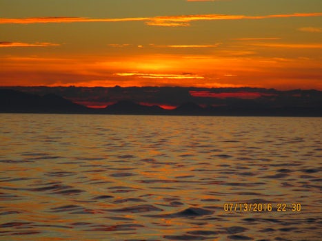 The quiet calm seas of the Alaskan Inside Passage highlighted by a beautiful sunset