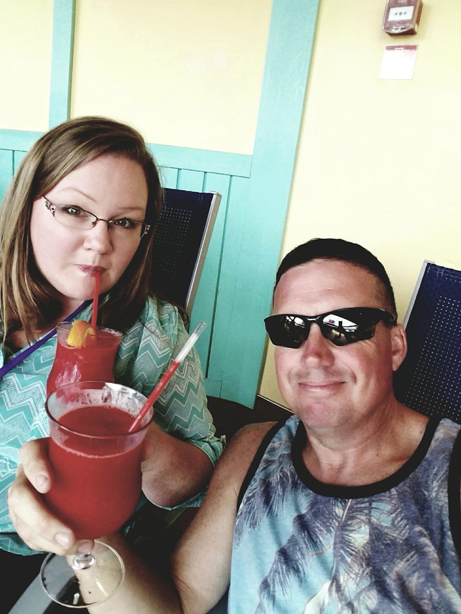 Enjoying an adult  beverage with my husband on the lido deck of the Carnival Breeze.