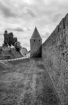 The outer walls of the medieval double walled town of Carcassonne, France.  While there may be many other tourists, it is well worth visiting as one can get a great insight into how life would have been in the middle ages.