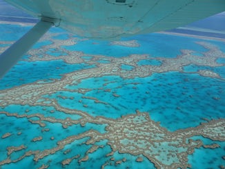 This is a view of the Great Barrier Reef taken from small airplane when ship was at Airlie Beach