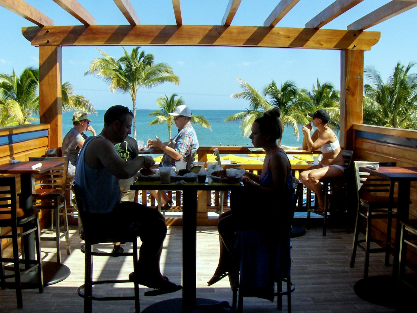 Silhouettes dining from the best view of Land Sharks Grill second floor at Harvest Caye Belize