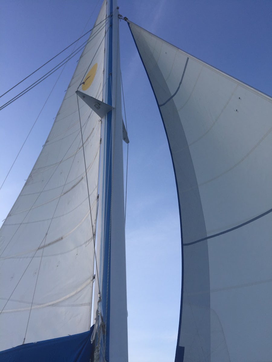 Lying on canvas in center of Catamaran to capture our two sails on our Sunset Catamaran Sail in St Maarten.