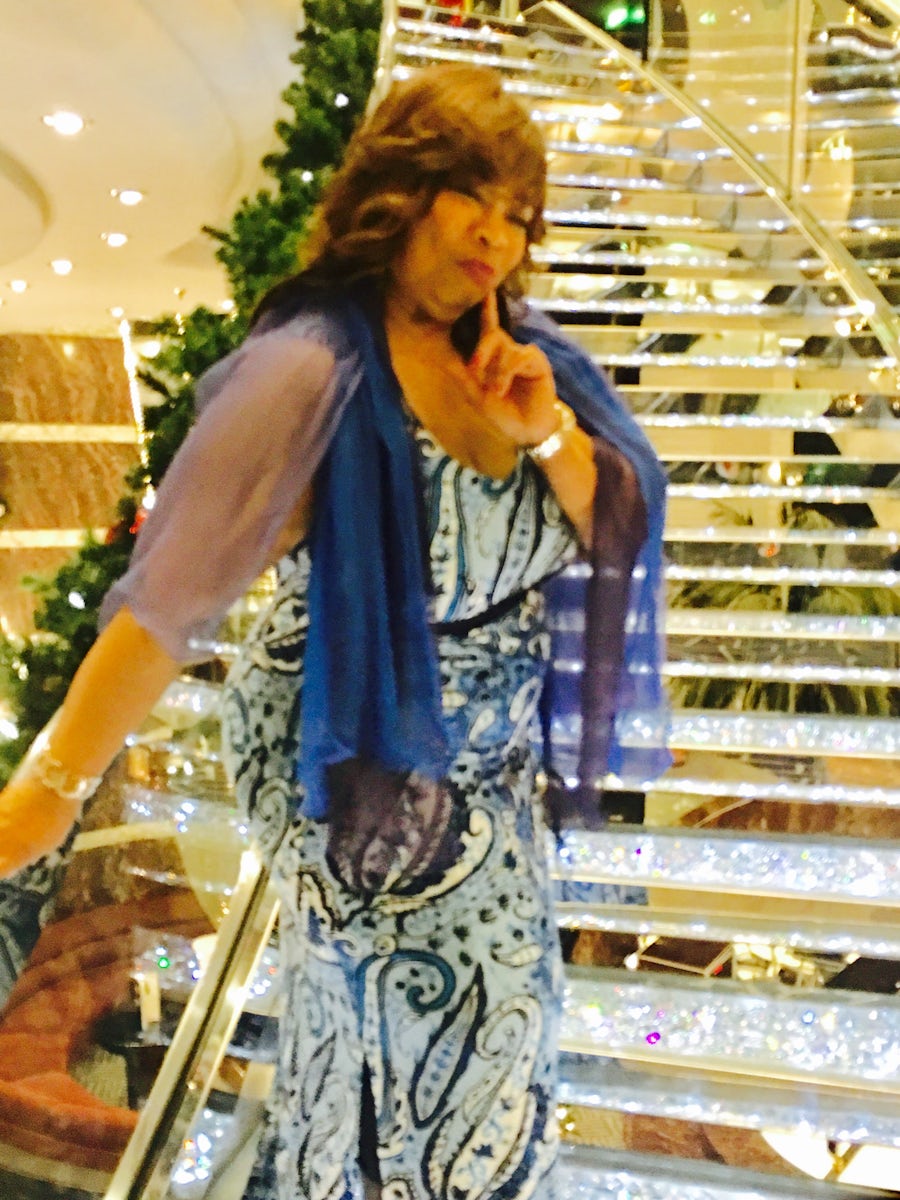 My sister who set up the beautiful cruise taking advantage of a picture perfect photo on the crystal staircase