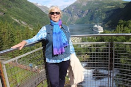 At the top of beautiful water falls in town of Geiranger Norway with fjord