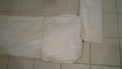 Use the towels to built barriers to prevent the water from slashing around