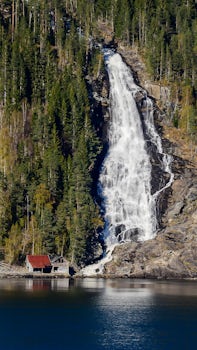 Cascading waterfall cruising through Fjords