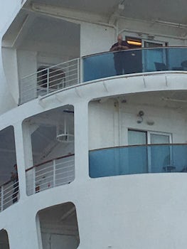 Cabin D727 is to the left of the man standing on his balcony. The window faces Starboard