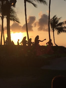 A picture of the Imu ceremony at the Paradise Cove Luau at sunset.