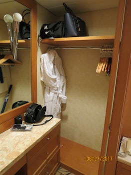 Split closet with vanity in the middle.