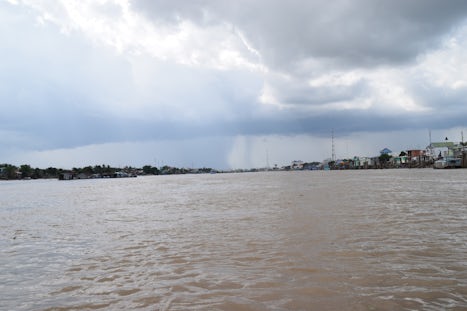 Travelling on the Mekong river on a small boat with a massive storm coming