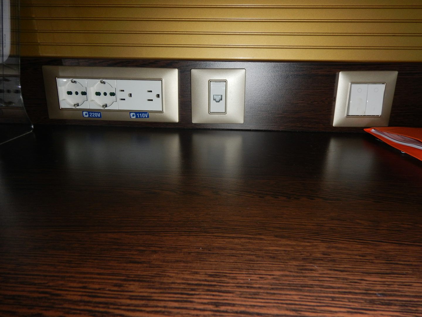 EU and US plugs on desk in cabin