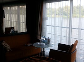 View from corner of stateroom with large mirror to the left and sliding gla