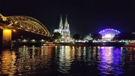 The nightlights As our riverboat sailed underneath  The bridge as we approach the city of Cologne