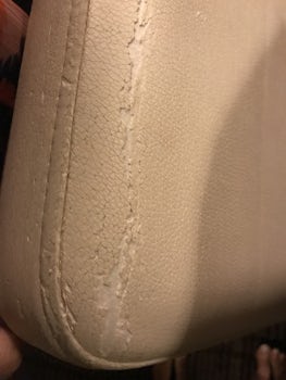 Torn and worn upholstery in cabin chair