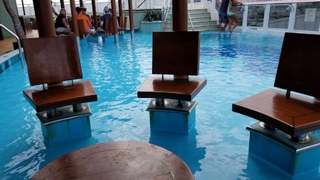 Havana seating under hut and near the pool. Soak you feet in water while ha