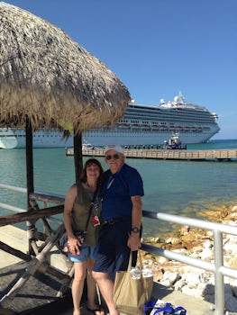My husband and I at Domincan Republic Amber Cove, Carnival  Conquest in background